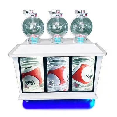 Front view of white three-cylinder pick 3 lottery machine, clear ball chambers and screens showing red numbered balls