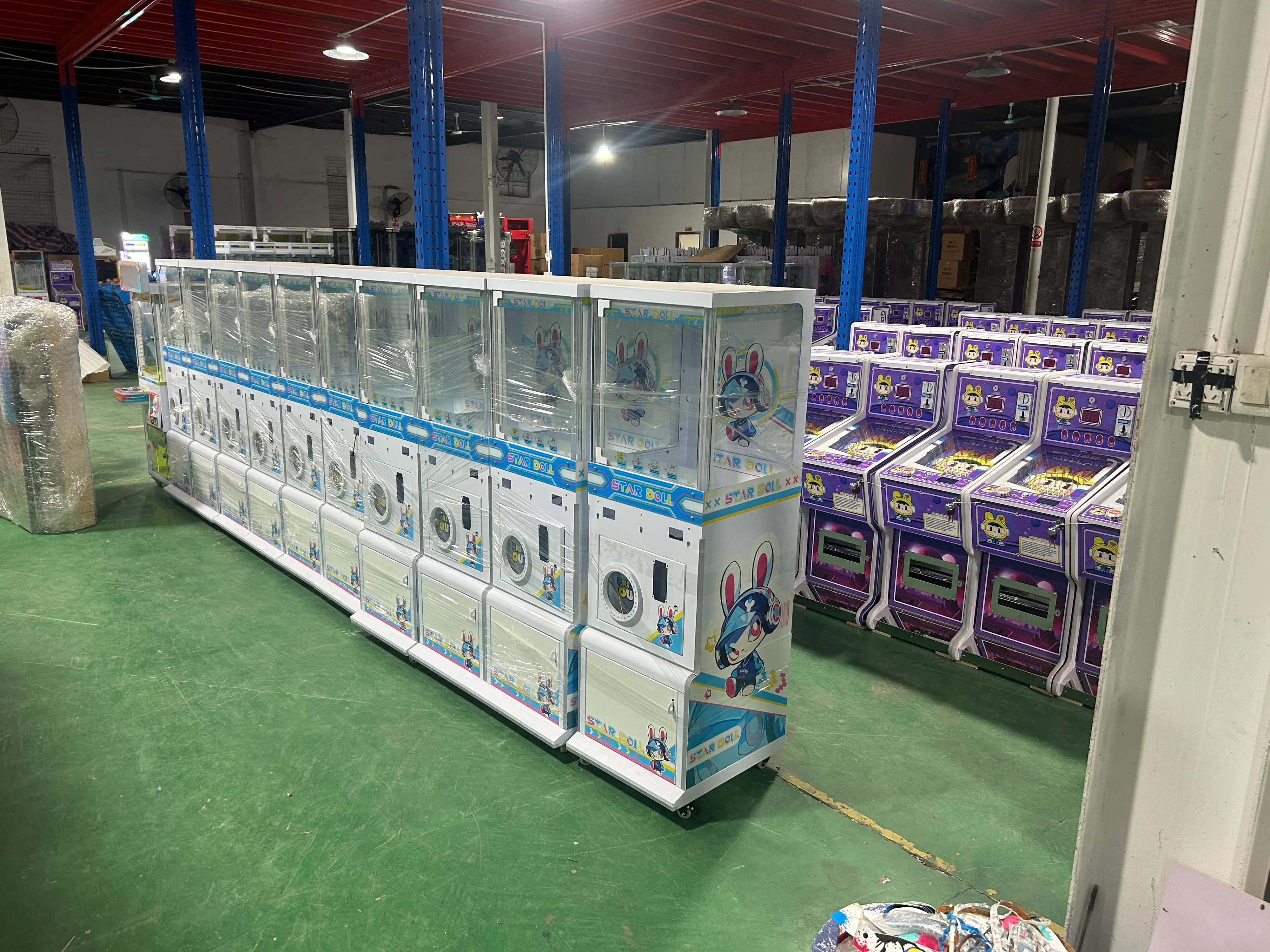 Finished claw and prize game cabinets lined up inside the Jisun factory