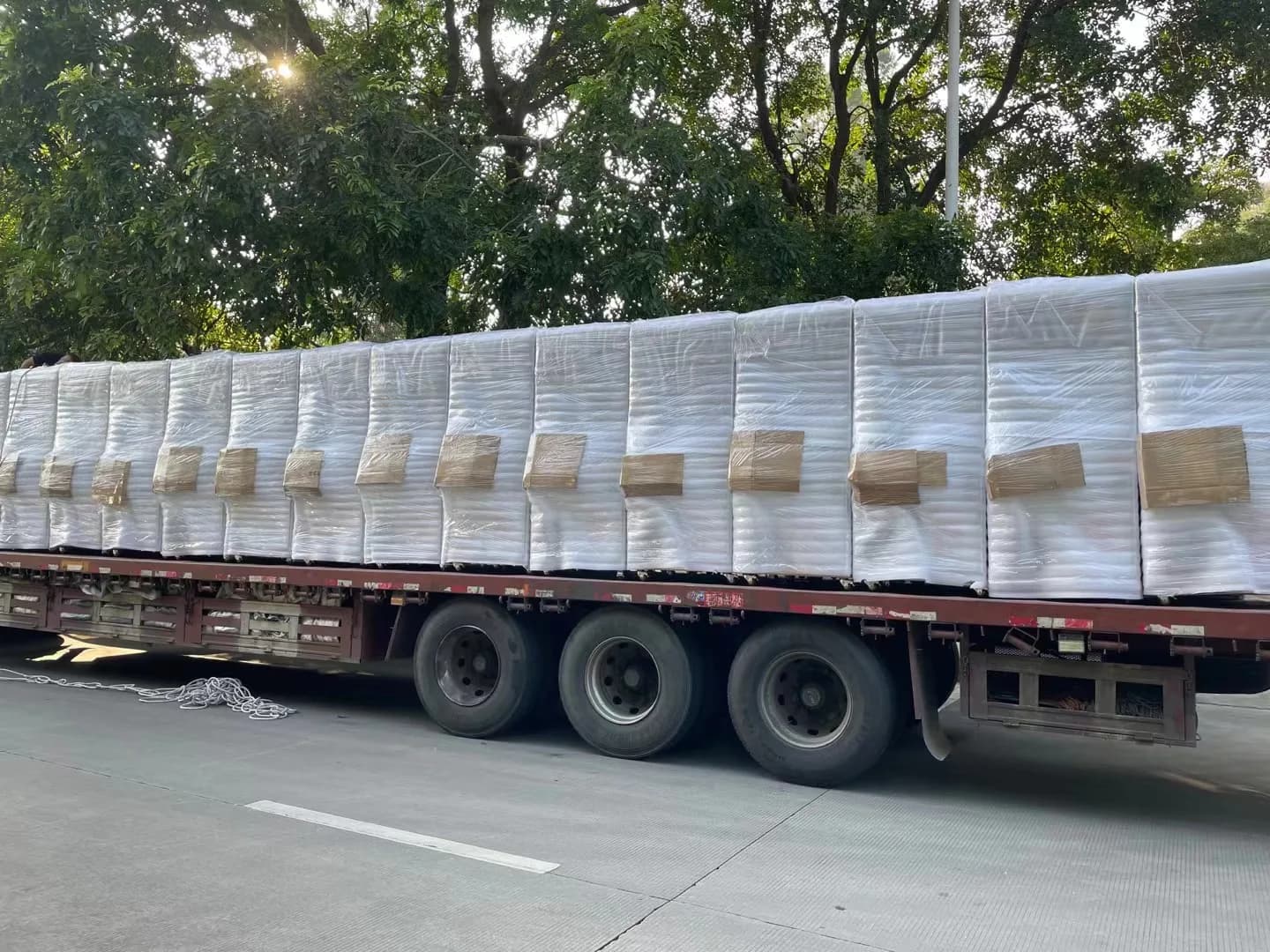 Foam-wrapped Jisun amusement machines protected by wooden shipping frames before loading