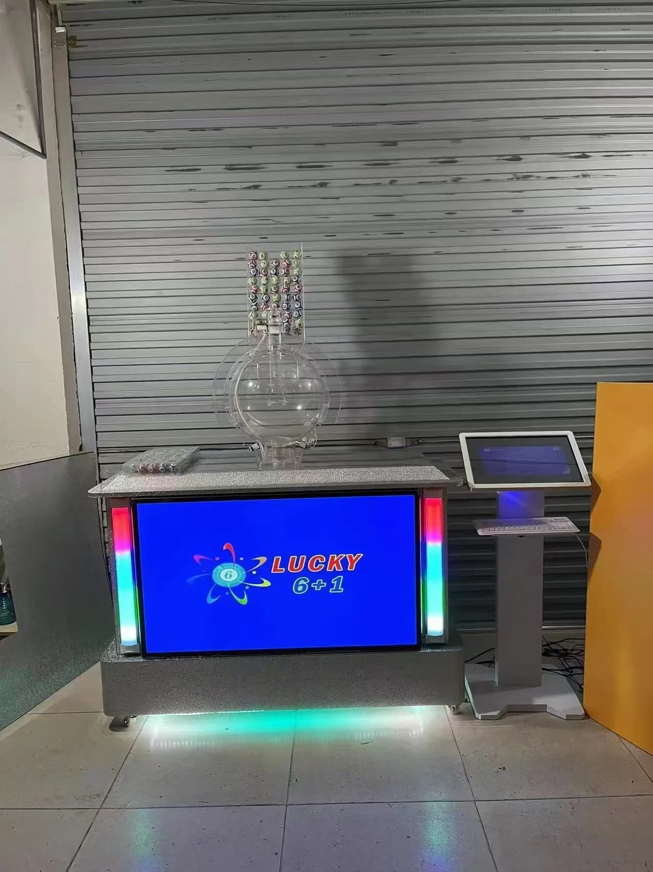 Jisun JX800 Lucky 6 plus 1 lottery draw machine powered on with display and ball chamber