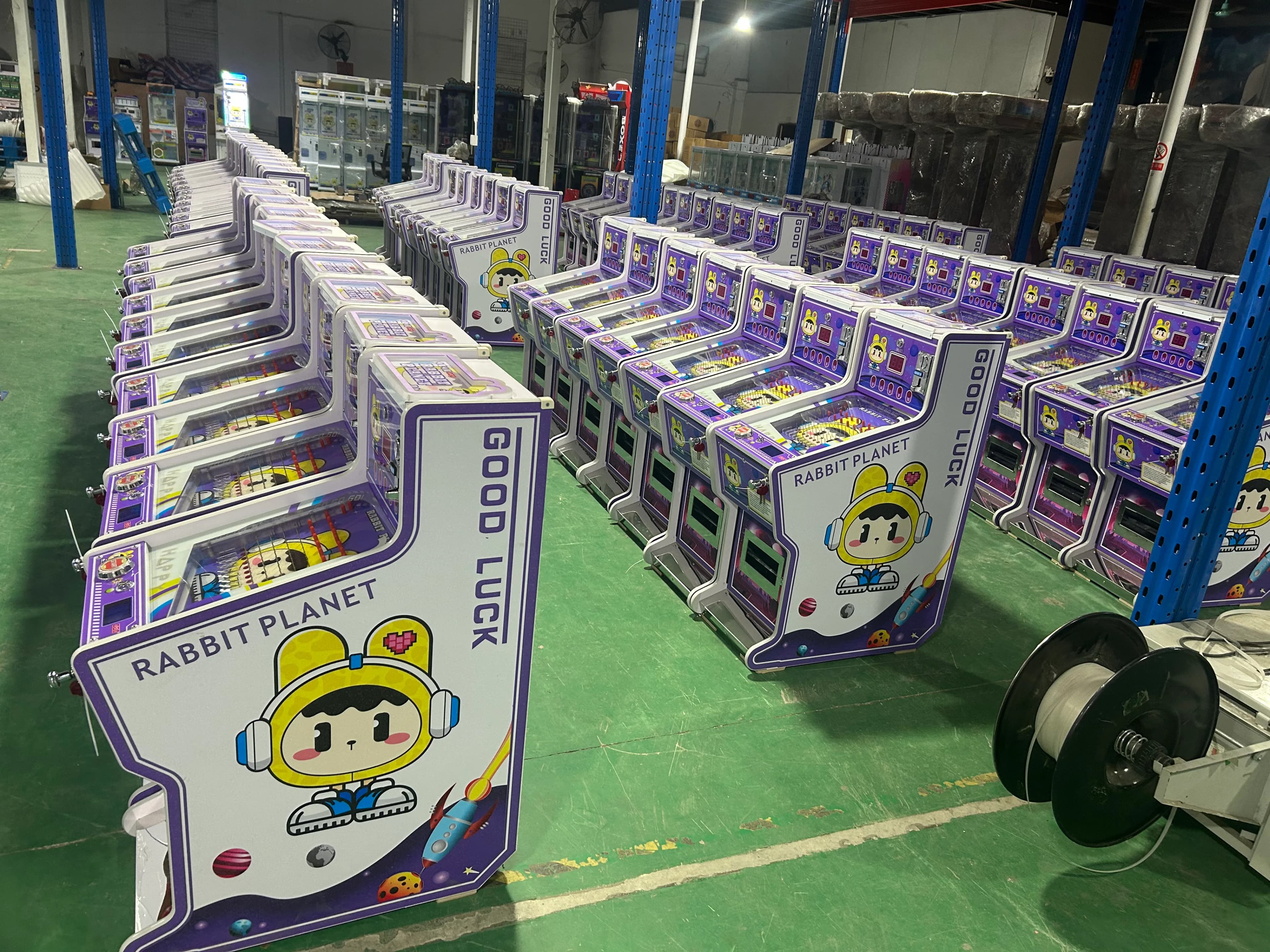 Dozens of Rabbit Planet prize game machines arranged in rows at the Jisun factory