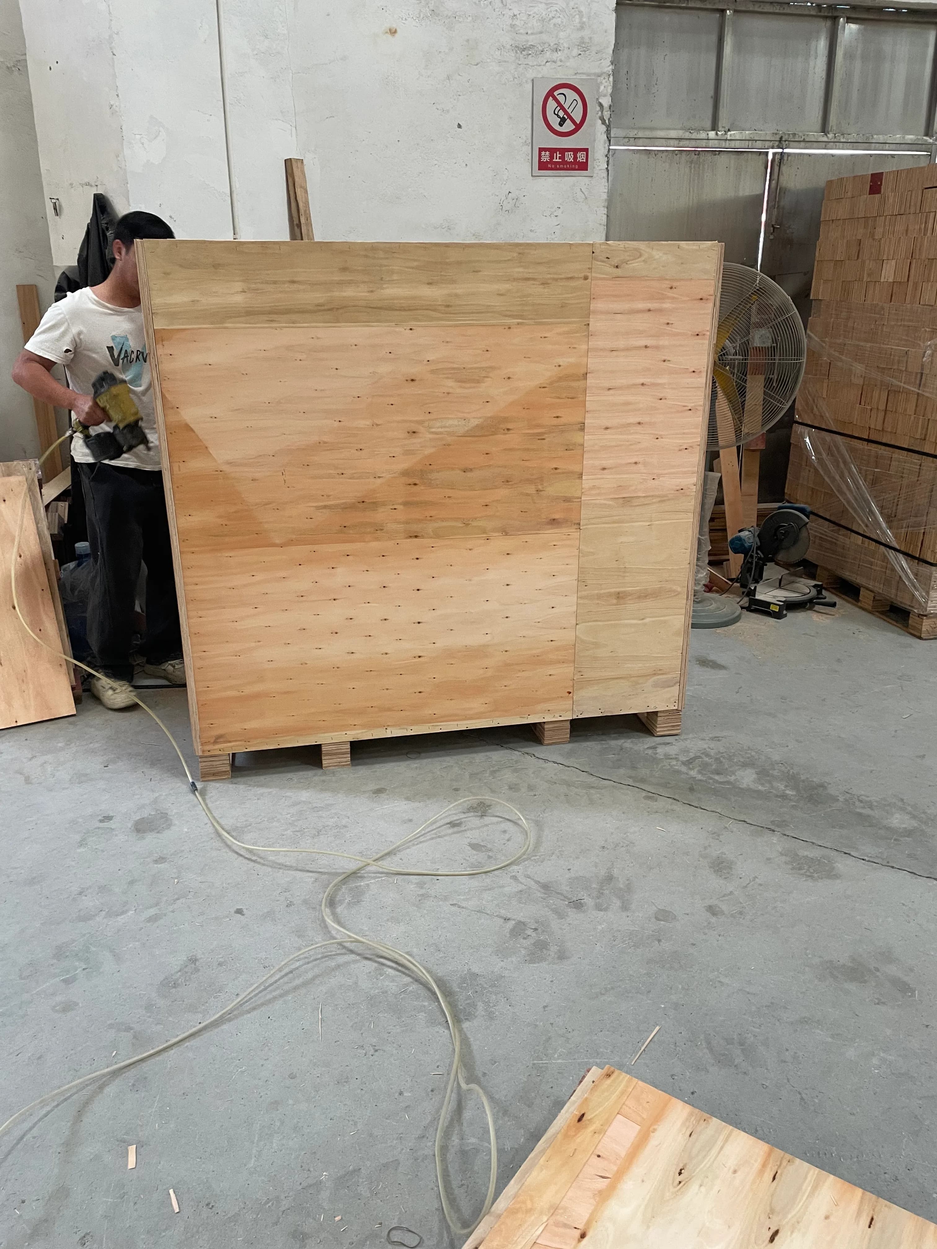Three lottery draw machines wrapped with film foam corners and protective covers before crating
