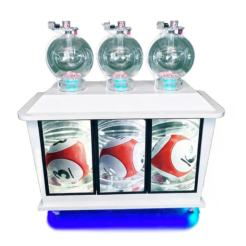 Front view of white three-cylinder pick 3 lottery machine, clear ball chambers and screens showing red numbered balls