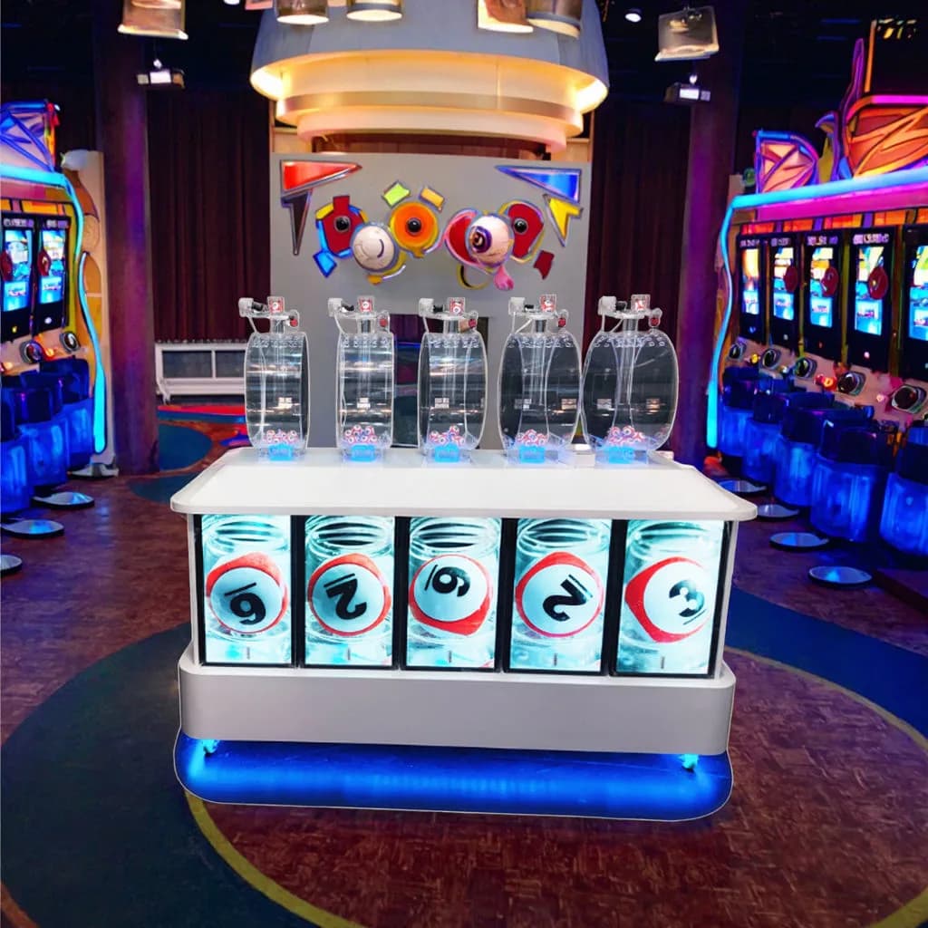 Front view of a 5P350 Pick 5 bingo machine with five clear mixing drums above an illuminated white console in a game hall