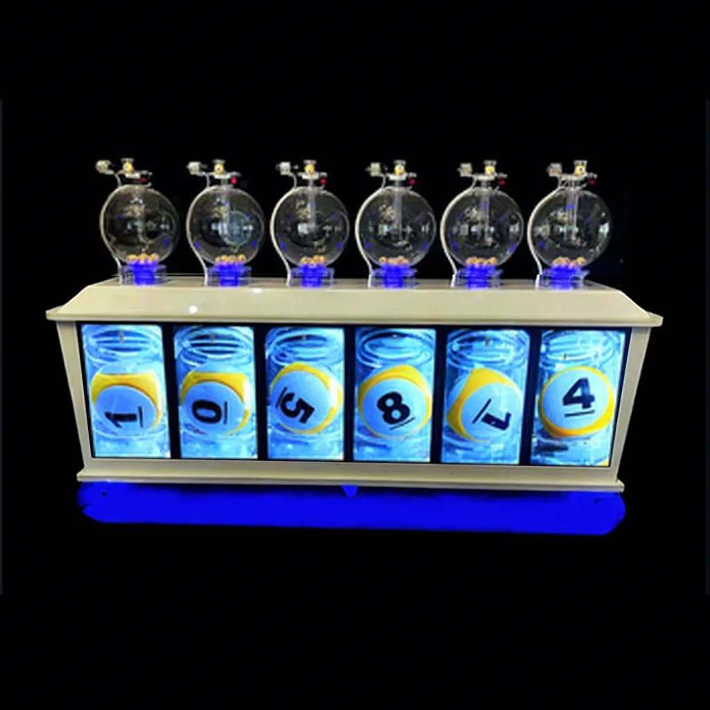 Front view of the 6D six-chamber lottery machine with blue LED base and number boards showing yellow balls 1, 0, 5, 8, 7, 4
