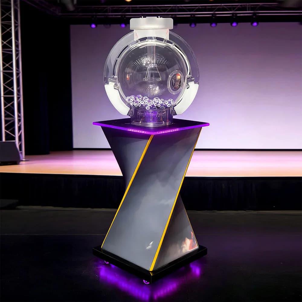 Front view of the MS04 Mark Six lottery machine on a twisted stand with purple LED lighting and numbered balls inside the clear globe