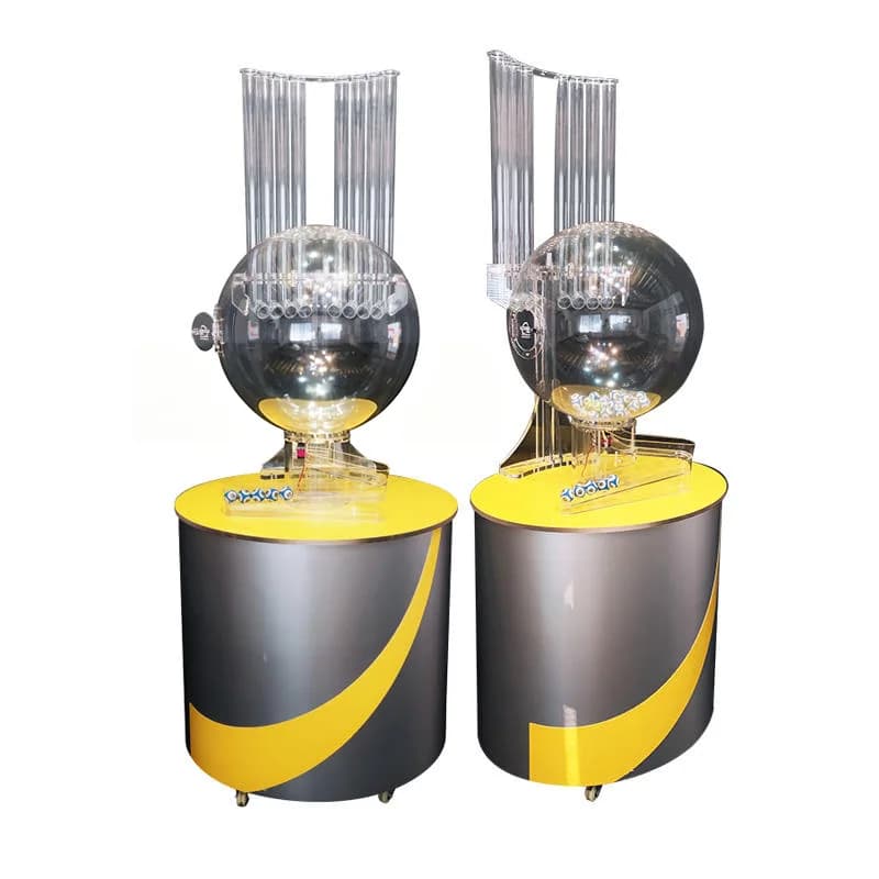 Two YP6002 air-blown lotto ball drawing machines with grey and yellow cabinets and clear mixing chambers on white background